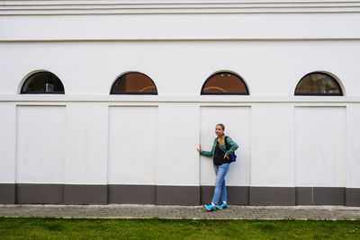 Young teen girl near the wall