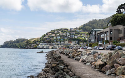 View of townscape by sea against sky