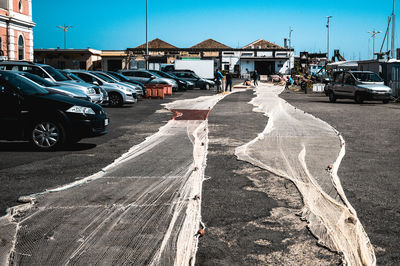 Vehicles on road by buildings in city