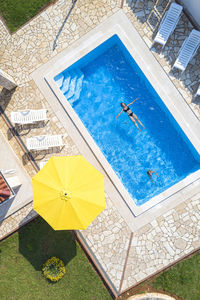 Aerial view of woman swimming in pool