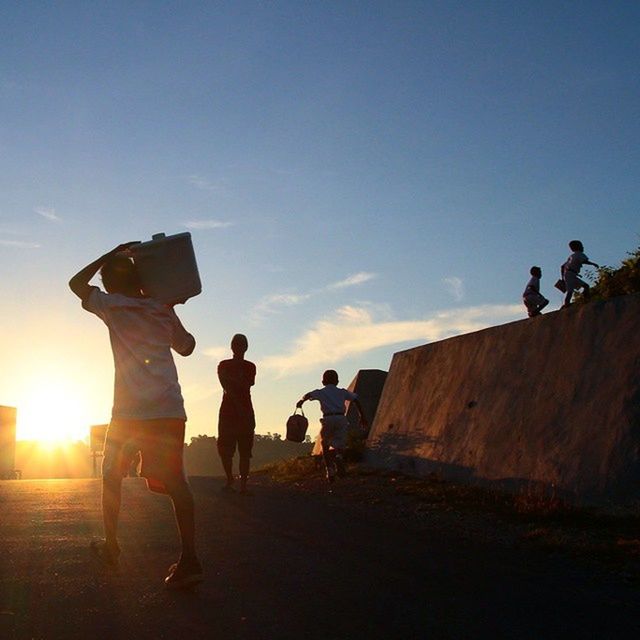 lifestyles, men, full length, leisure activity, walking, person, togetherness, sun, sky, sunlight, silhouette, rear view, friendship, clear sky, the way forward, bonding, sunbeam