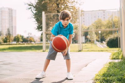 Full length of boy playing with ball