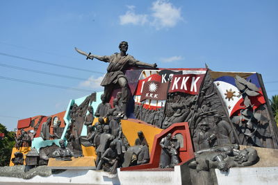 Low angle view of statues against sky