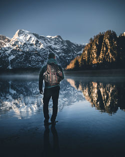 Full length of man standing by lake against sky