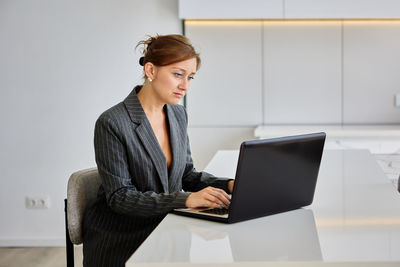 Businesswoman using laptop at office