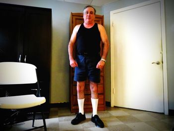 Portrait of young man standing at home