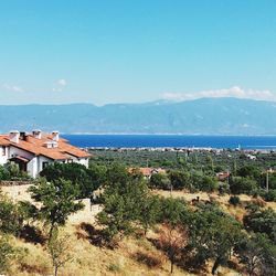 Scenic view of sea and buildings against sky