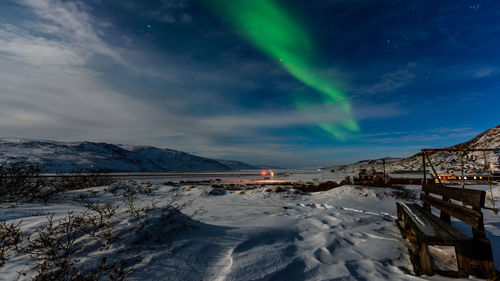 Scenic view of snowcapped mountains against sky at night