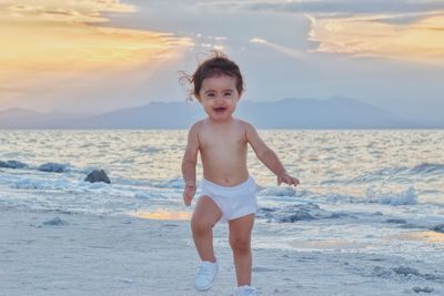 Portrait of shirtless boy on beach