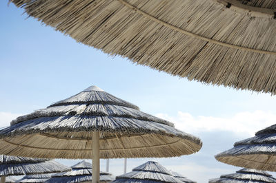 Low angle view of parasols against sky