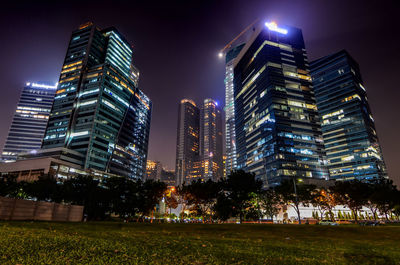 View of skyscrapers lit up at night