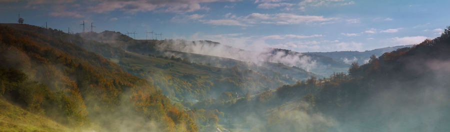 Panoramic view of rainbow over mountains against sky