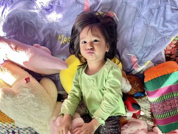 Portrait of cute girl relaxing on bed at home