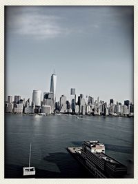 River in front of cityscape against sky