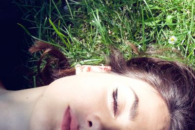 Close-up of woman lying on grass
