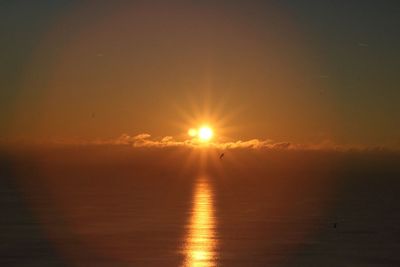 Scenic view of sea against sky at sunset