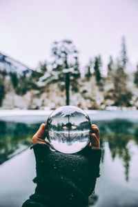 Close-up of hand holding crystal ball