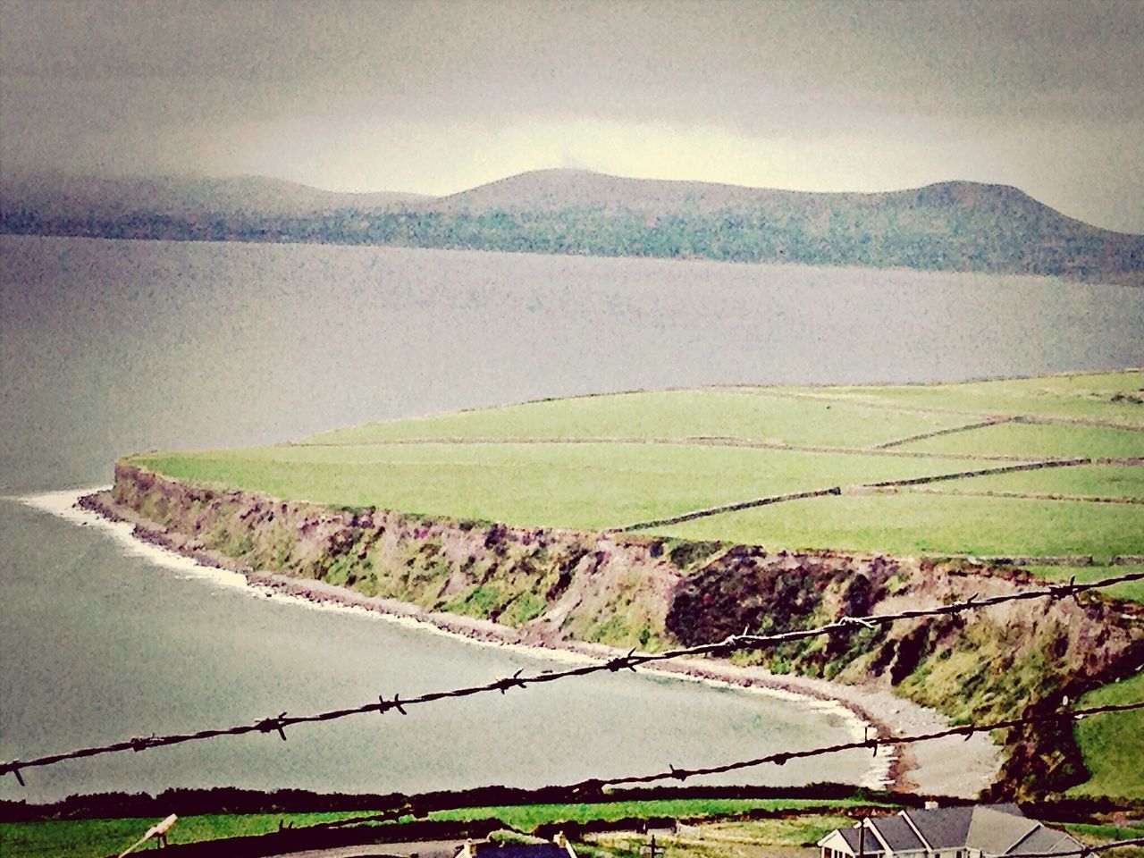 tranquil scene, mountain, tranquility, water, landscape, scenics, beauty in nature, nature, grass, sky, mountain range, high angle view, green color, field, idyllic, connection, river, day, sea, outdoors