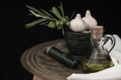 Close-up of vase on table against black background