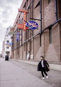 People on street amidst buildings in city