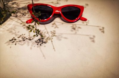 Close-up of sunglasses on red table