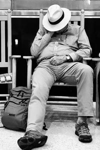 Midsection of man sitting on chair