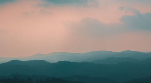 Scenic view of silhouette mountains against sky during sunset