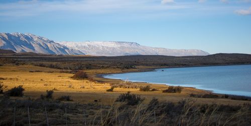 Scenic view of lake and mountains against sky