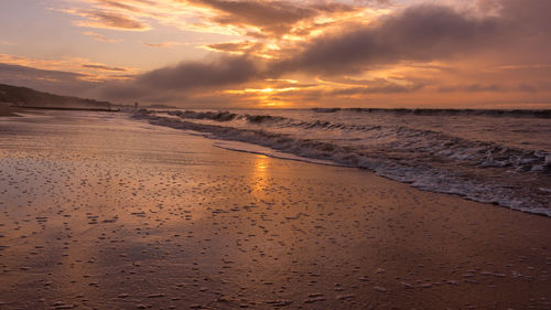 Scenic view of beach against sky during sunset