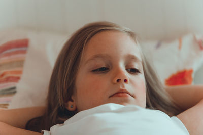 Portrait of woman lying on bed at home