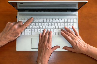 High angle view of man using laptop on table