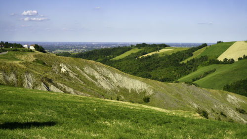 Scenic view of landscape and sea against sky