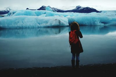 Full length of man standing in lake during winter