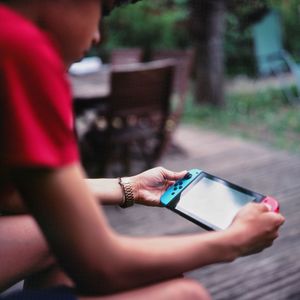 Midsection of man using mobile phone