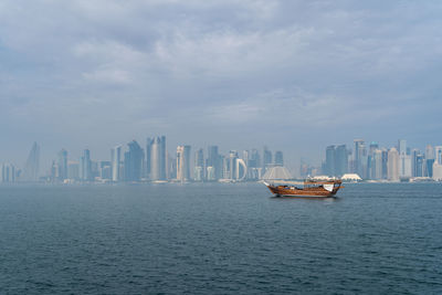 Boats in sea against sky