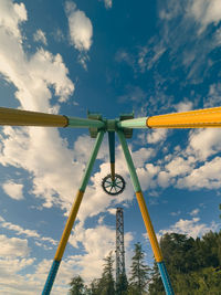 Low angle view of pendulum ride mid swing against sky