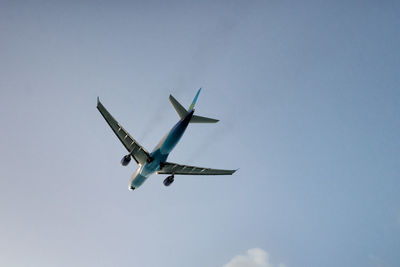 Low angle view of airplane flying in sky