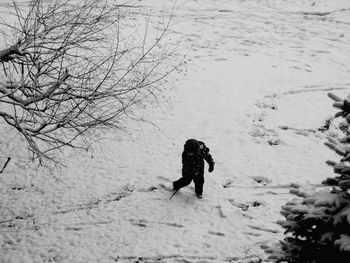 Man walking on snow covered land