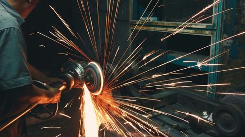 Midsection of man working in factory