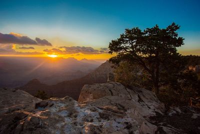 Scenic view of rocky mountains against sky during sunset