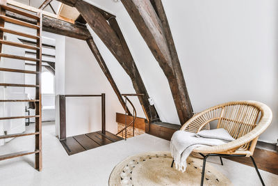 Empty chairs and table against wall at home