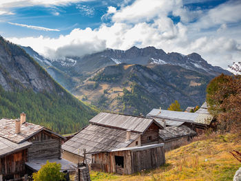 Scenic view of houses and mountains against sky