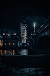 Illuminated queen elisabeth tower and big ben against sky at night from westminster bridge