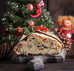 High angle view of cake with christmas decorations on wooden table