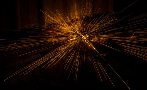 Low angle view of firework display at night