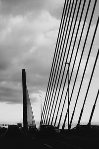 Low angle view of suspension bridge against sky