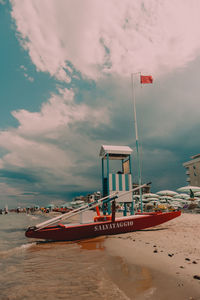 Lifeguard hut on beach against sky