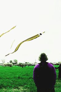 Rear view of man standing on field