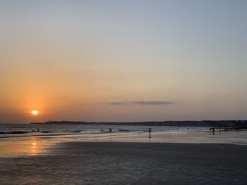 Scenic view of beach against sky during sunset