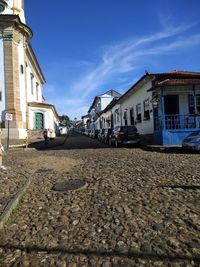 Surface level of street amidst buildings against sky